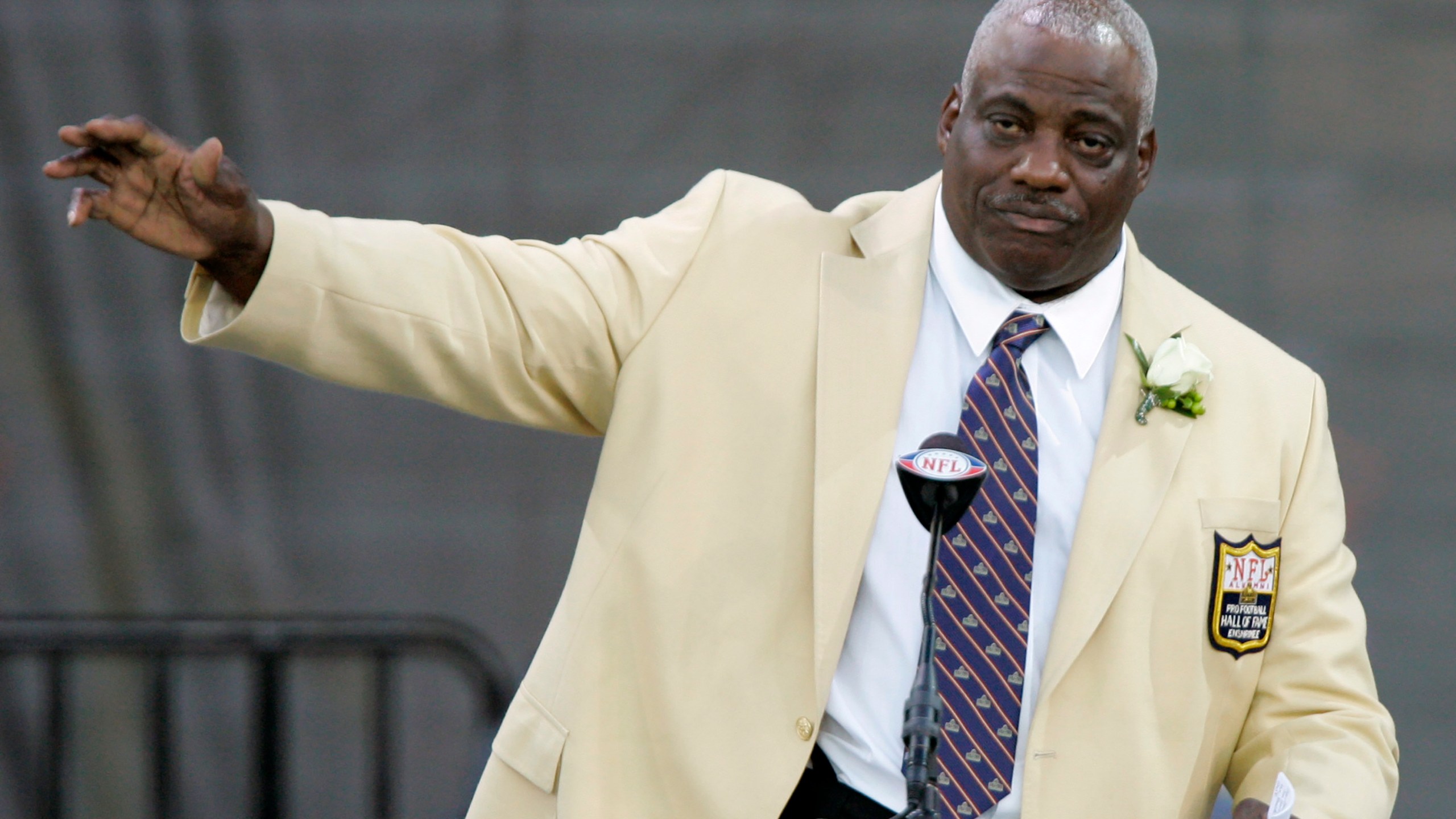 In this Aug. 2, 2008, file photo, former San Diego Chargers defensive end Fred Dean waves to fans after his speech at the Pro Football Hall of Fame, in Canton, Ohio. Dean, the fearsome pass rusher who was a key part of the launch of the San Francisco 49ers' dynasty, has died. (Mark Duncan/Associated Press)