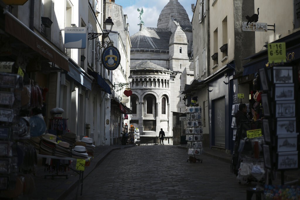 Tourists shops are empty in a deserted street just outside the Sacre Coeur basilica in the Montmartre district of Paris on Oct. 15, 2020. (AP Photo/Lewis Joly)