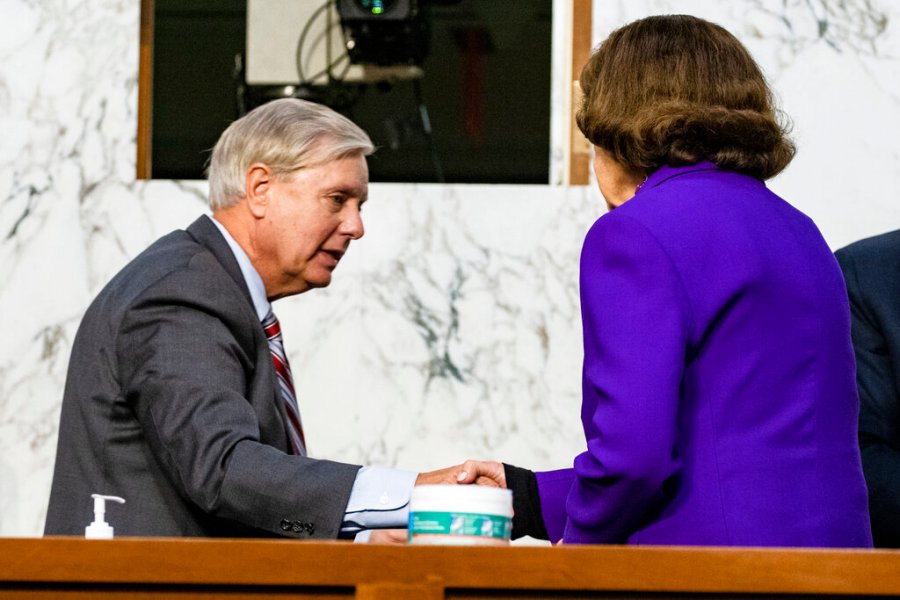 Sen. Lindsey Graham, R-S.C., shakes hands with Sen. Dianne Feinstein, D-Calif., at the close of the confirmation hearing for Supreme Court nominee Amy Coney Barrett, before the Senate Judiciary Committee on Oct. 15, 2020, on Capitol Hill in Washington. (Samuel Corum/Pool via AP)