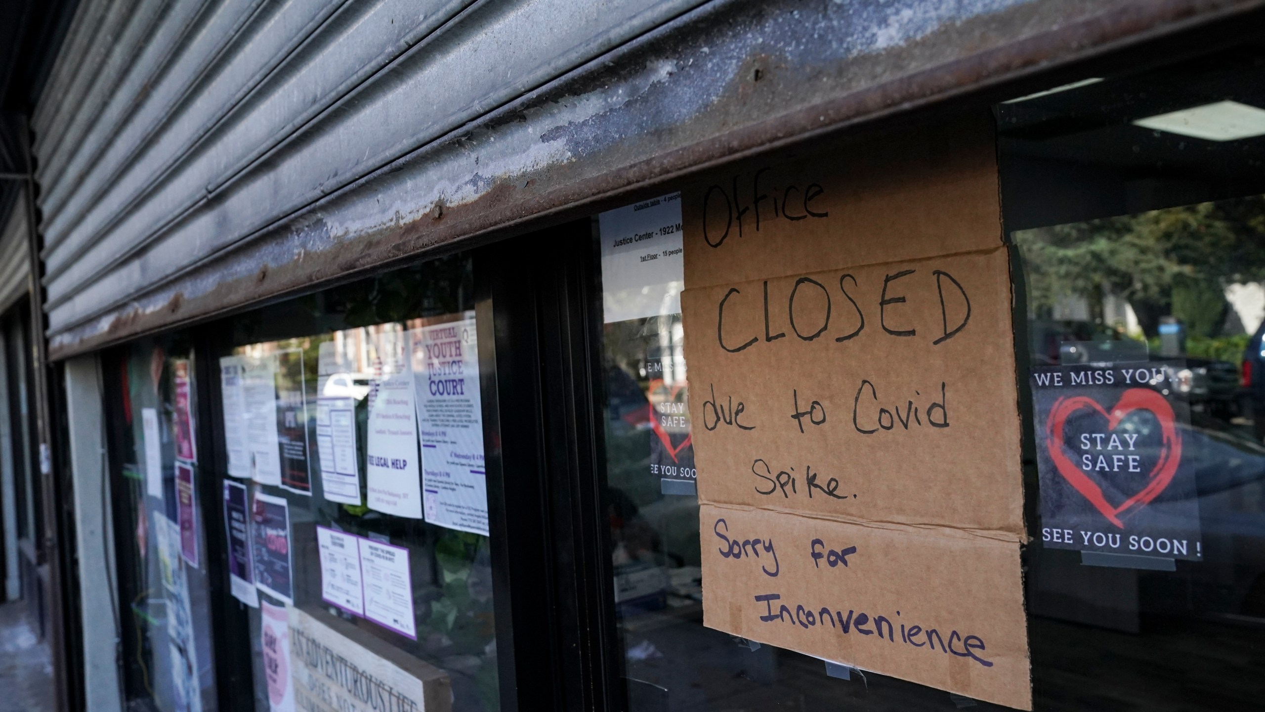 A storefront displays a closed sign as it remains shuttered due to a COVID-19 area infection rate increase, Thursday, Oct. 15, 2020, in the Far Rockaway neighborhood of the borough of Queens in New York. (AP Photo/John Minchillo)