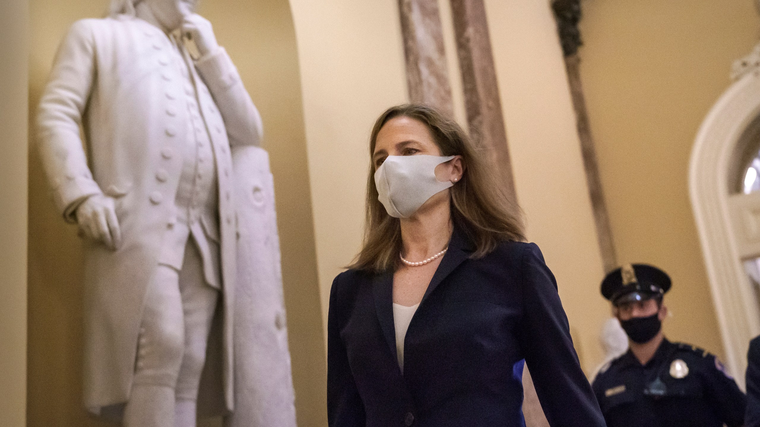 Judge Amy Coney Barrett, President Donald Trump's nominee for the Supreme Court, arrives for closed meetings with senators, at the Capitol in Washington, Wednesday, Oct. 21, 2020. (AP Photo/J. Scott Applewhite)