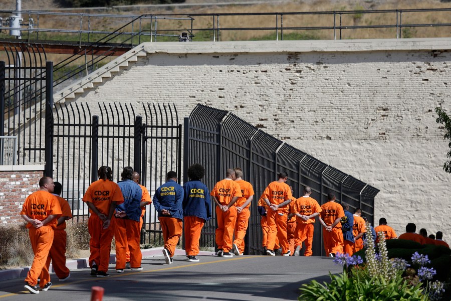 In this Aug. 16, 2016, file photo, general population inmates walk in a line at California's San Quentin State Prison. (AP Photo/Eric Risberg, File)