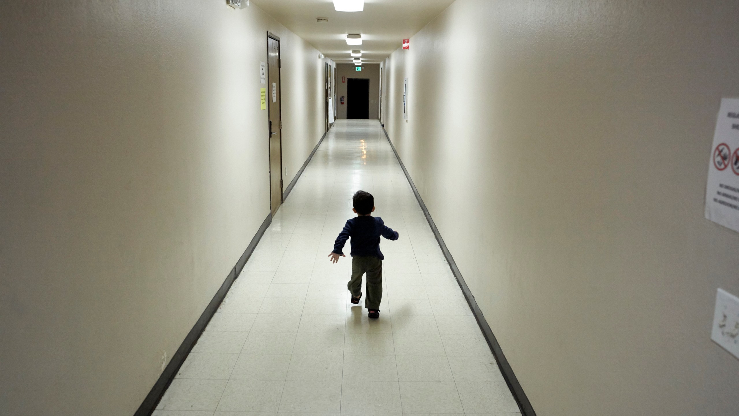 In this Dec. 11, 2018, file photo, an asylum-seeking boy from Central America runs down a hallway after arriving from an immigration detention center to a shelter in San Diego. (Gregory Bull/Associated Press)