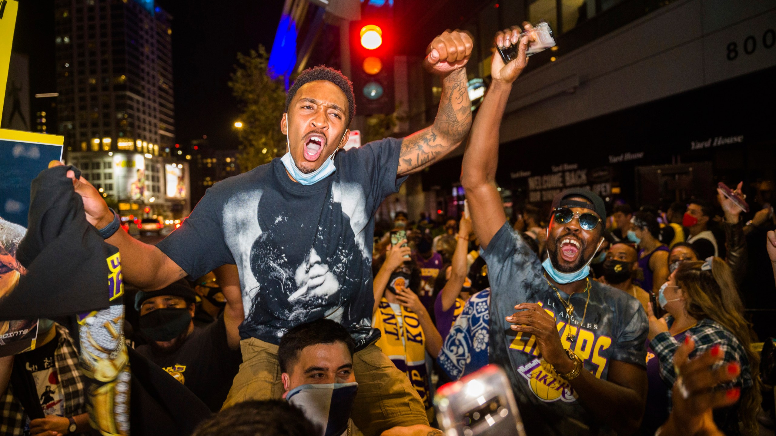 Fans in Los Angeles celebrate after the Lakers defeated the Miami Heat in Game 6 of the NBA Finals to win the championship on Oct. 11, 2020. (Jintak Han / Associated Press)