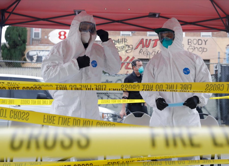 In this Monday, April 20, 2020, file photo members with Los Angeles Fire Department wear protective equipment at a COVID-19 testing site in the Skid Row district in Los Angeles. (AP Photo/Marcio Jose Sanchez, File)