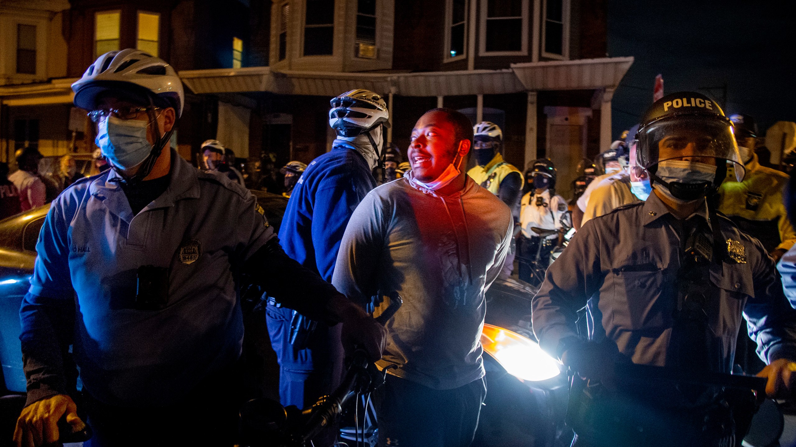 A person is handcuffed and detained by police in Philadelphia on Oct. 28, 2020, two days after Walter Wallace Jr. was killed by police officers. (Tom Gralish/The Philadelphia Inquirer via Associated Press)