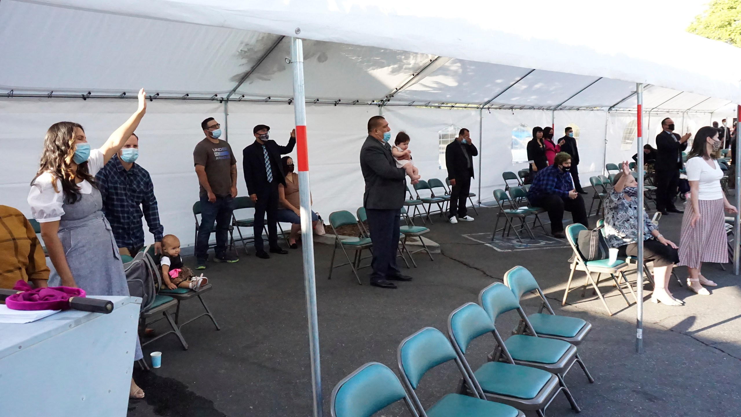 In a photo provided by Word Aflame Ministries, people are outdoors during a service at Word Aflame Tabernacle in La Habra Heights. (Word Aflame Ministries via Associated Press)