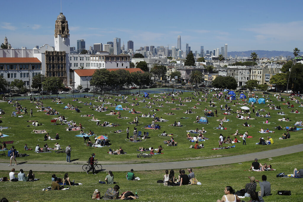 Visitors set up inside circles designed to help prevent the spread of the coronavirus by encouraging social distancing at Dolores Park in San Francisco on May 24, 2020.(AP Photo/Jeff Chiu, File)