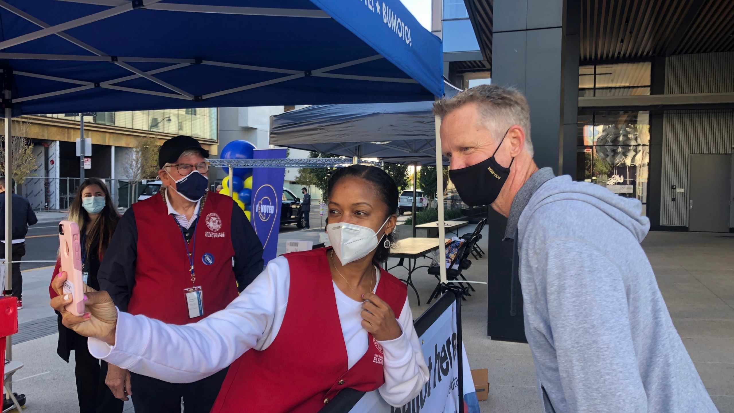 Golden State Warriors coach Steve Kerr poses for a selfie with voting worker Jujuana Williams of Oakland on Saturday, Oct. 31, in San Francisco. (Janie McCauley/AP Photo)