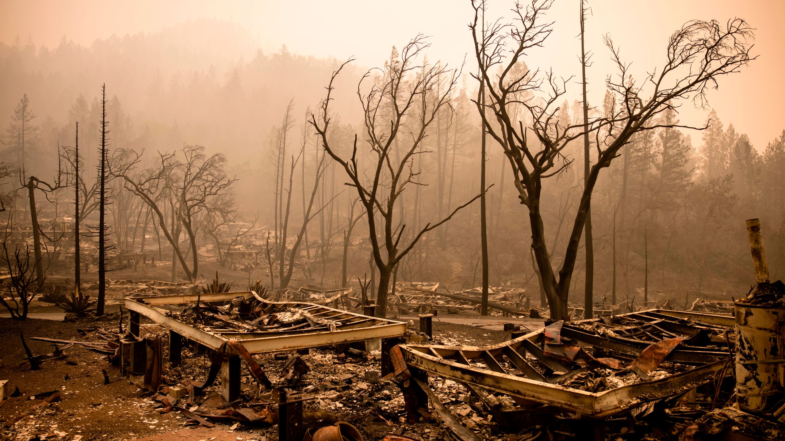 The remains of the guest houses at Calistoga Ranch smoulder after the Glass Fire passed through in, Calistoga, Napa Valley, California on Sept. 30, 2020. (SAMUEL CORUM/AFP via Getty Images)