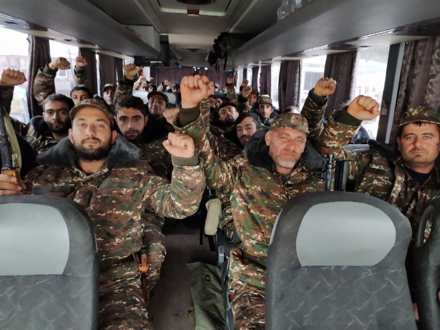 Ethnic Armenian volunteers and reservists ride in a bus towards the Karabakh frontline to fight with Azeri troops during the ongoing military conflict over the breakaway Nagorno-Karabakh region on Oct. 6, 2020. (AFP via Getty Images)