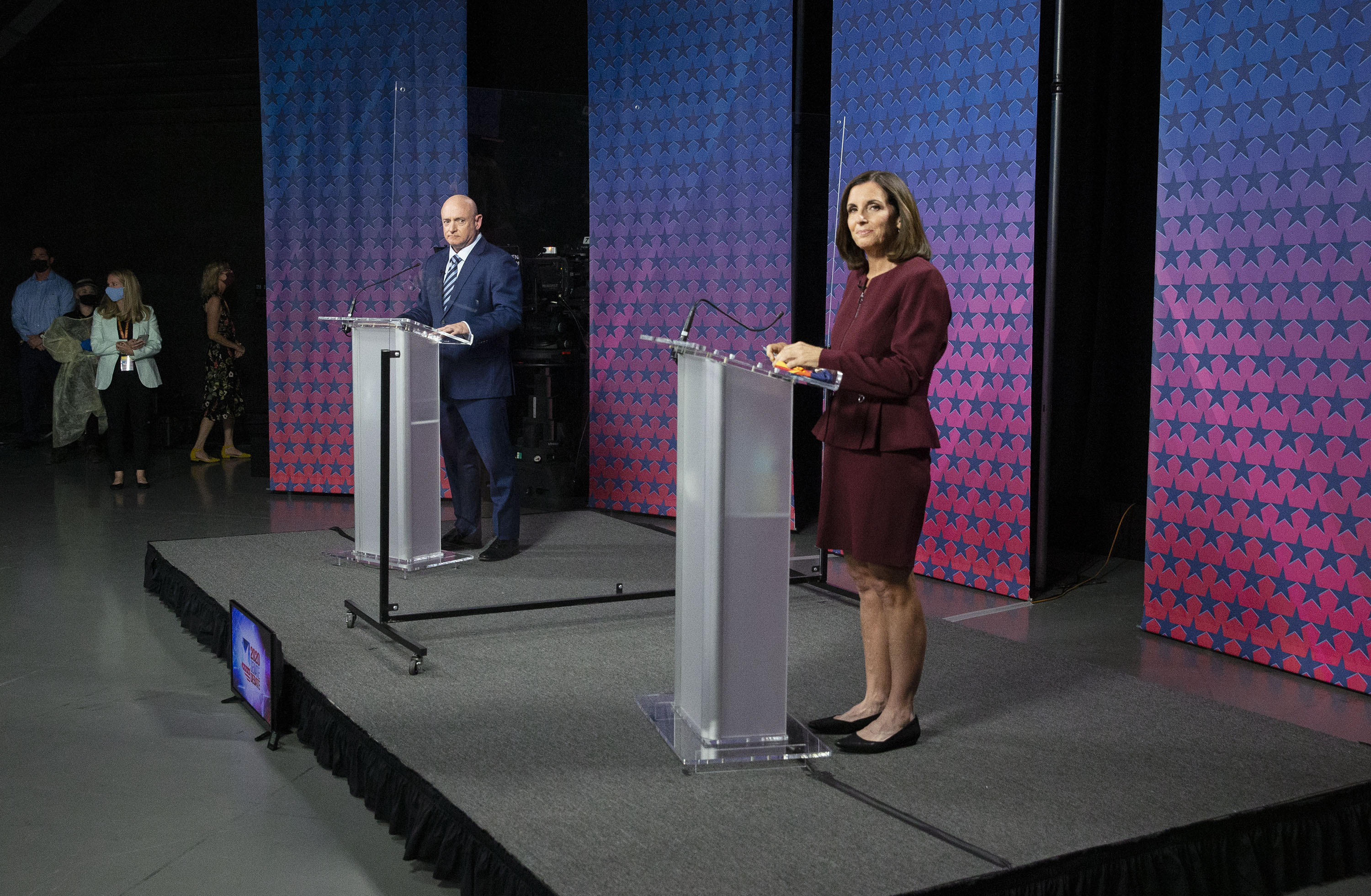 U.S. Senator Martha McSally (R-AZ) and Democratic challenger Mark Kelly are separated by plexiglass as they participate in a debate at the Walter Cronkite School of Journalism at Arizona State University in Phoenix, Arizona, on October 6, 2020. (Photo by Rob SCHUMACHER / POOL / AFP) (Photo by ROB SCHUMACHER/POOL/AFP via Getty Images)