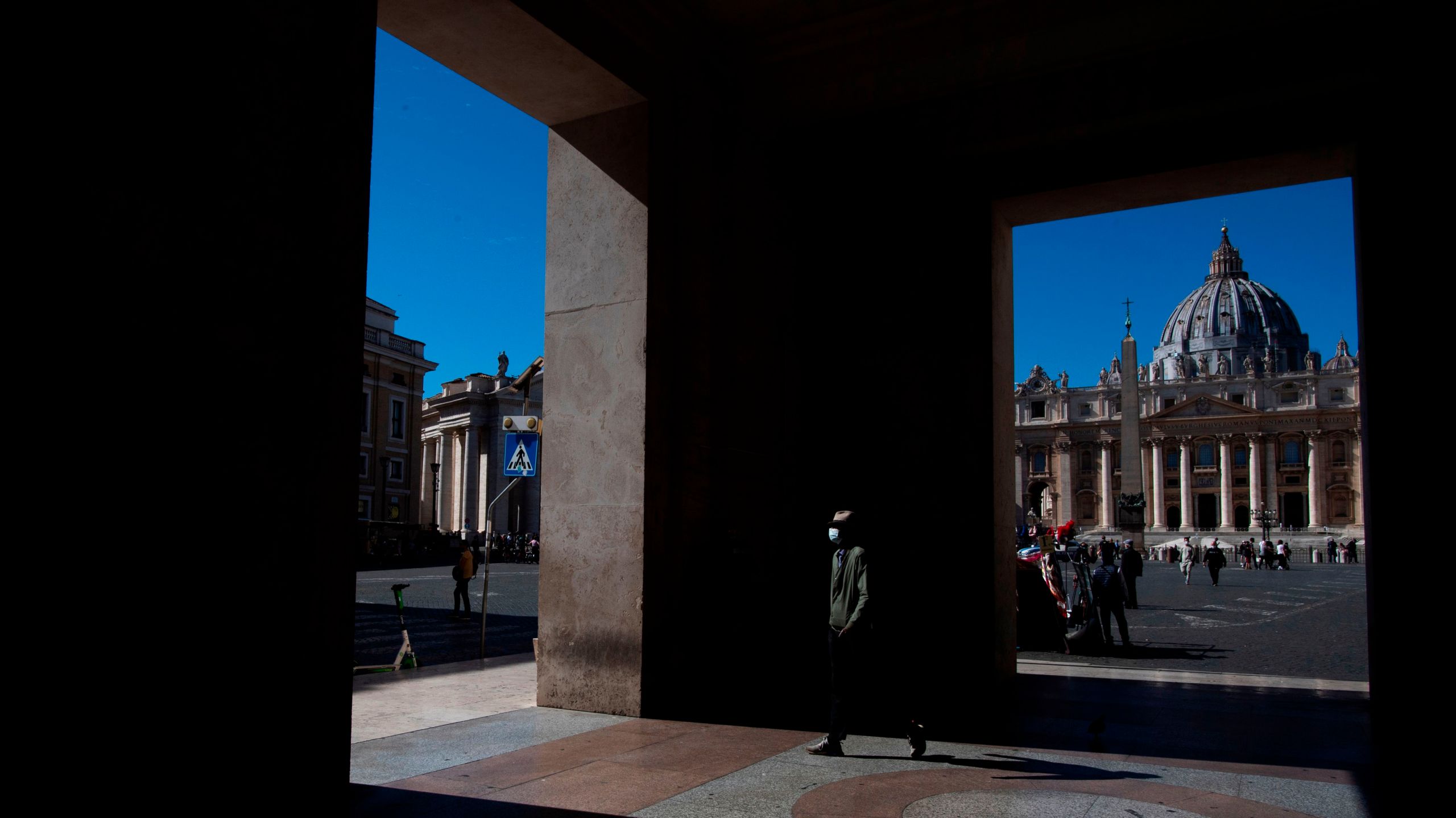 A man wearing a protective mask passes by St. Peter's Square at the Vatican on October 8, 2020. (Tiziana FABI / AFP) (Photo by TIZIANA FABI/AFP via Getty Images)