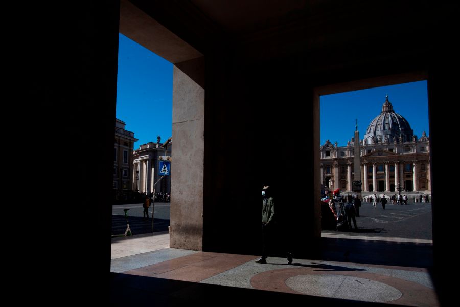 A man wearing a protective mask passes by St. Peter's Square at the Vatican on October 8, 2020. (Tiziana FABI / AFP) (Photo by TIZIANA FABI/AFP via Getty Images)