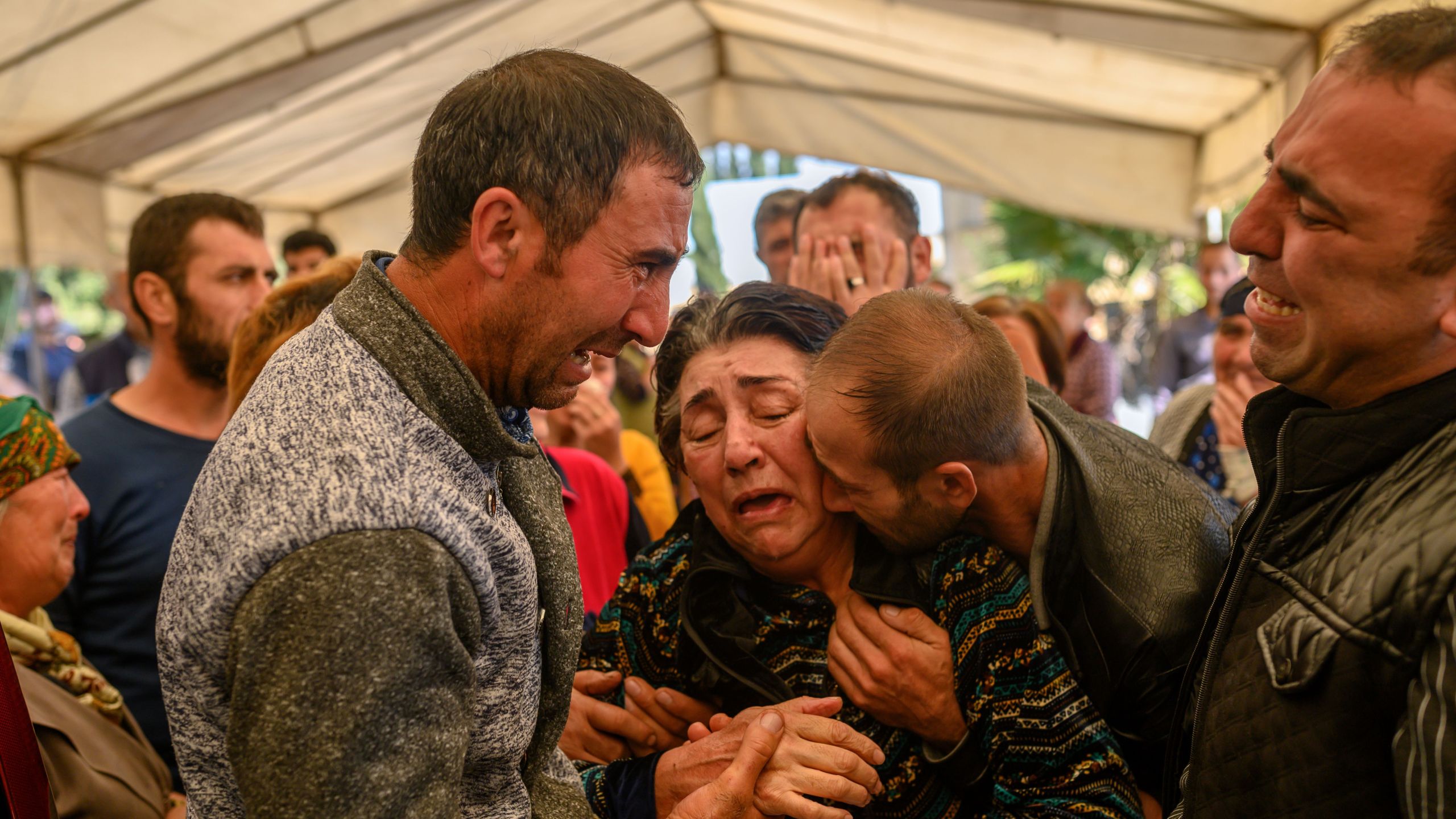 Relatives of Royal Sahnazarov, his wife Zuleyha Sahnazarova and their daughter Medine Sahnazorava, who were killed when a rocket hit their home, mourn during their funeral in the city of Ganja, Azerbaijan, on Oct. 17, 2020 during fighting over the breakaway region of Nagorno-Karabakh. (BULENT KILIC/AFP via Getty Images)