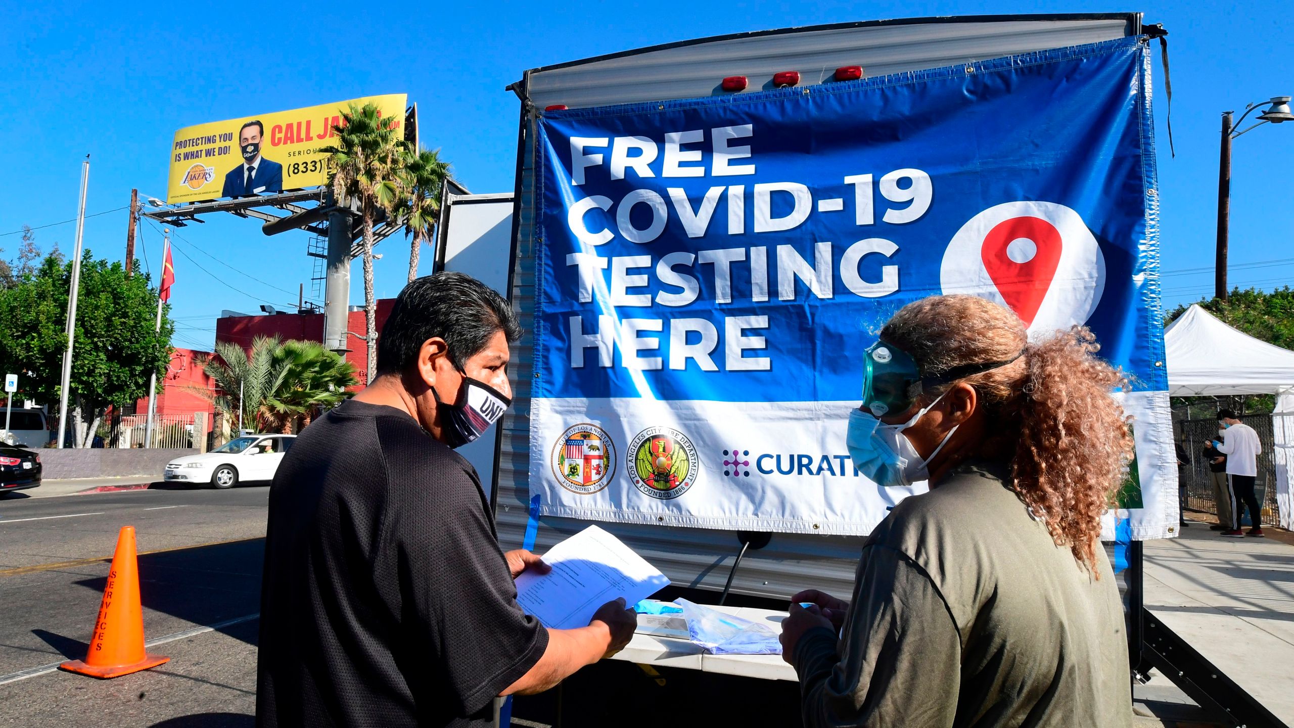 A man asks a volunteer questions at a pop-up COVID-19 test site in Los Angeles on Oct. 29, 2020. (FREDERIC J. BROWN/AFP via Getty Images)