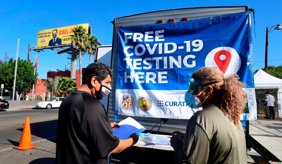 A man asks a volunteer questions at a pop-up COVID-19 test site in Los Angeles on Oct. 29, 2020. (FREDERIC J. BROWN/AFP via Getty Images)