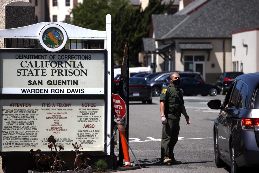 A California Department of Corrections and Rehabilitation (CDCR) officer wears a protective mask as he stands guard at the front gate of San Quentin State Prison on June 29, 2020. (Justin Sullivan/Getty Images)