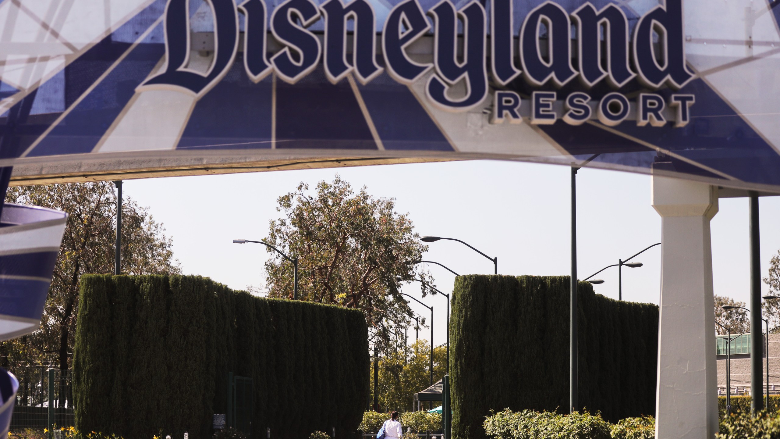 A person walks into an entrance to Disneyland in Anaheim on Sept. 30, 2020. (Mario Tama / Getty Images)