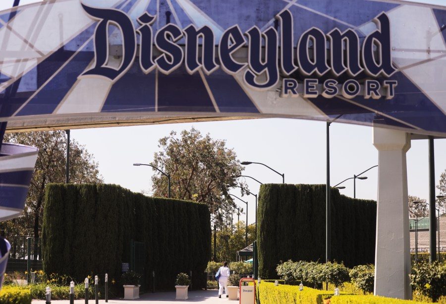 A person walks into an entrance to Disneyland in Anaheim on Sept. 30, 2020. (Mario Tama / Getty Images)