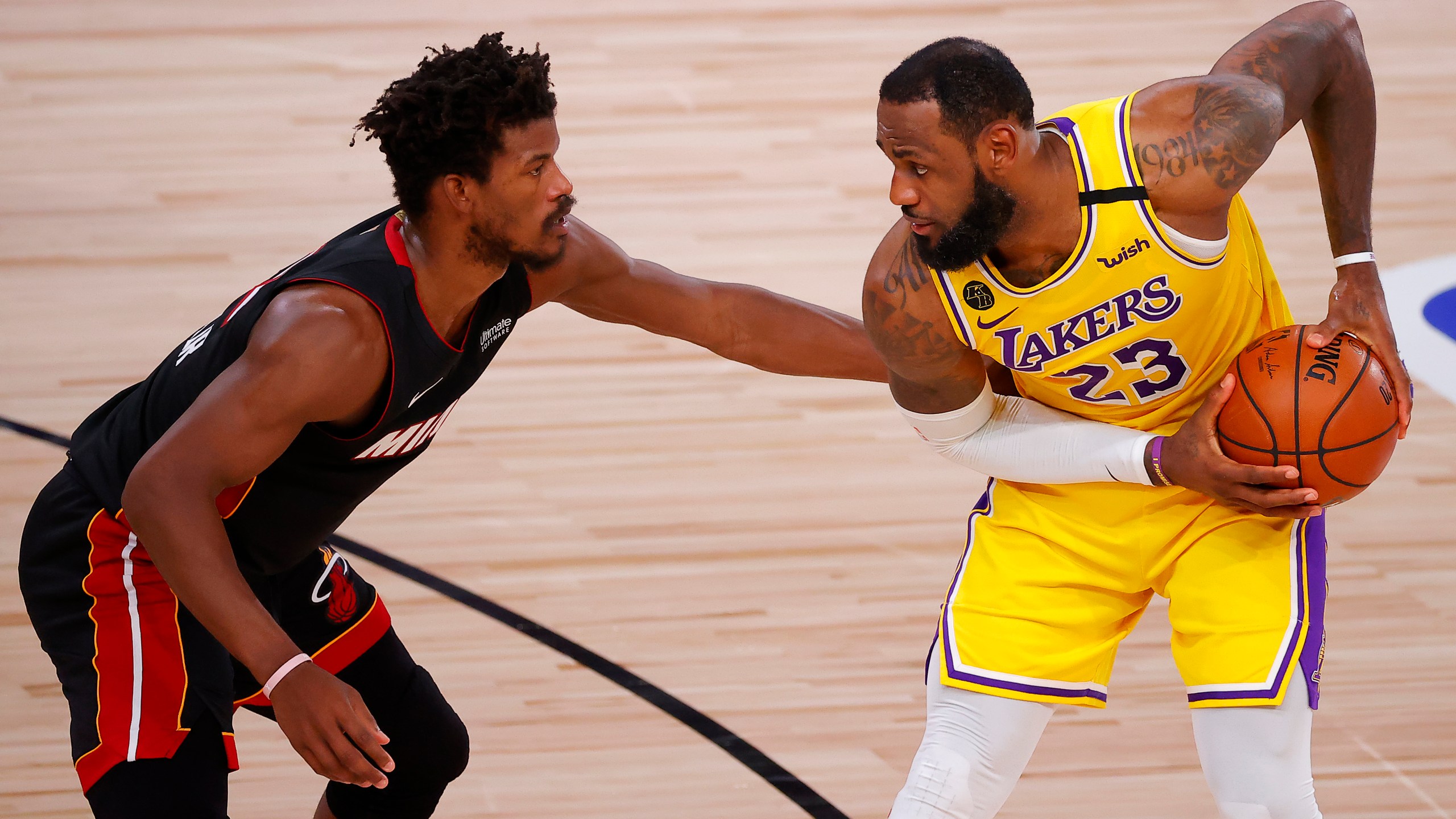 Jimmy Butler of the Miami Heat, left, defends LeBron James of the Los Angeles Lakers in Game Four of the 2020 NBA Finals in Florida on Oct. 6, 2020. (Kevin C. Cox / Getty Images)