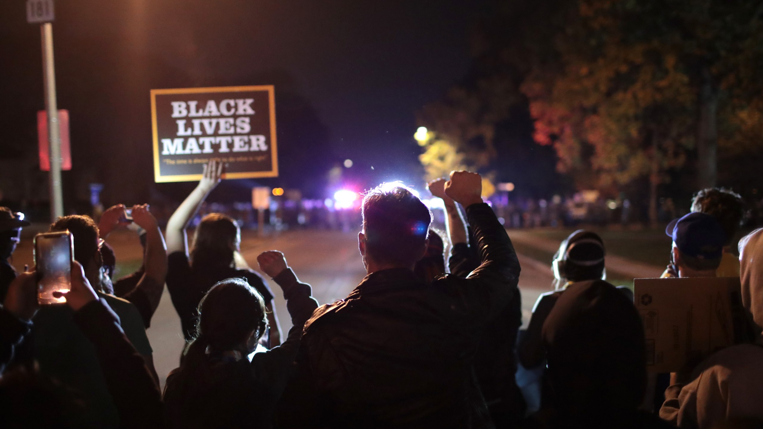 Protestors face police as they demonstrate near the Wauwatosa City Hall on Oct. 9, 2020, in Wauwatosa, Wisconsin. The city has faced three days of demonstrations, prompting a 7 p.m. curfew, after District Attorney John Chisholm refused to press charges against Wauwatosa Police Officer Joseph Mensah in the Feb. 2, 2020, fatal shooting of 17-year-old Alvin Cole. (Scott Olson/Getty Images)