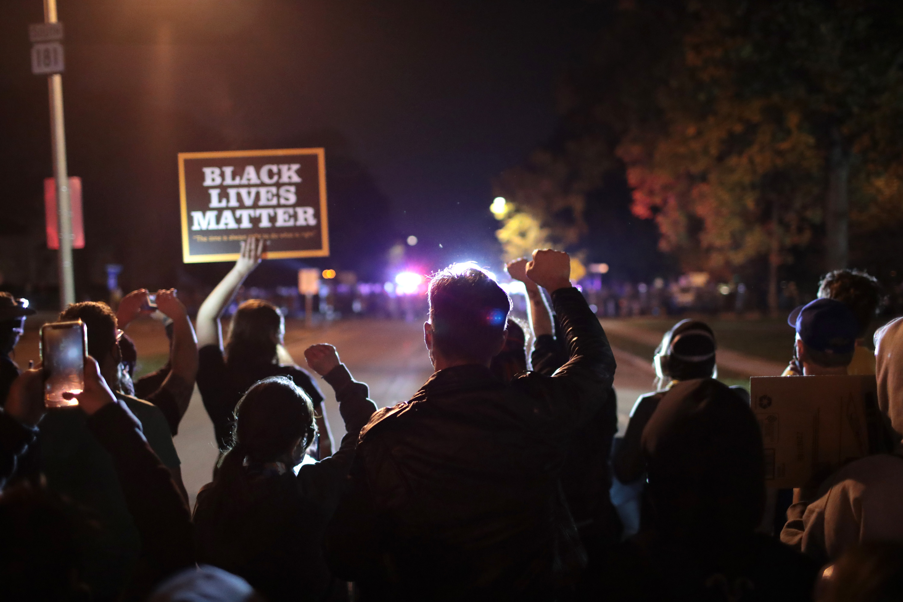 Protestors face police as they demonstrate near the Wauwatosa City Hall on Oct. 9, 2020, in Wauwatosa, Wisconsin. The city has faced three days of demonstrations, prompting a 7 p.m. curfew, after District Attorney John Chisholm refused to press charges against Wauwatosa Police Officer Joseph Mensah in the Feb. 2, 2020, fatal shooting of 17-year-old Alvin Cole. (Scott Olson/Getty Images)