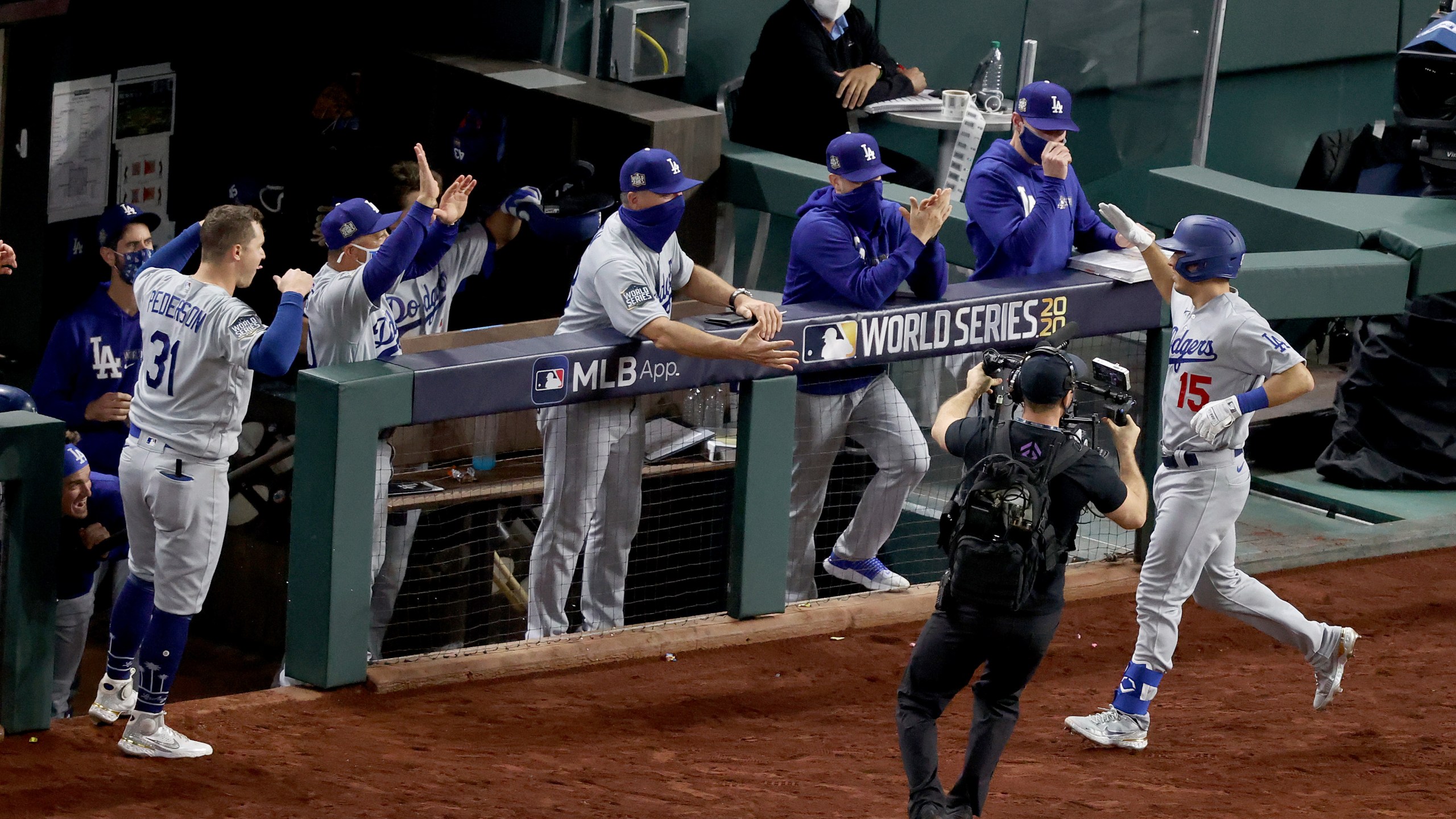 Austin Barnes #15 of the Los Angeles Dodgers is congratulated by his teammates after hitting a solo home run against the Tampa Bay Rays during the sixth inning in Game Three of the 2020 MLB World Series at Globe Life Field on Oct. 23, 2020 in Arlington, Texas. (Tom Pennington/Getty Images)