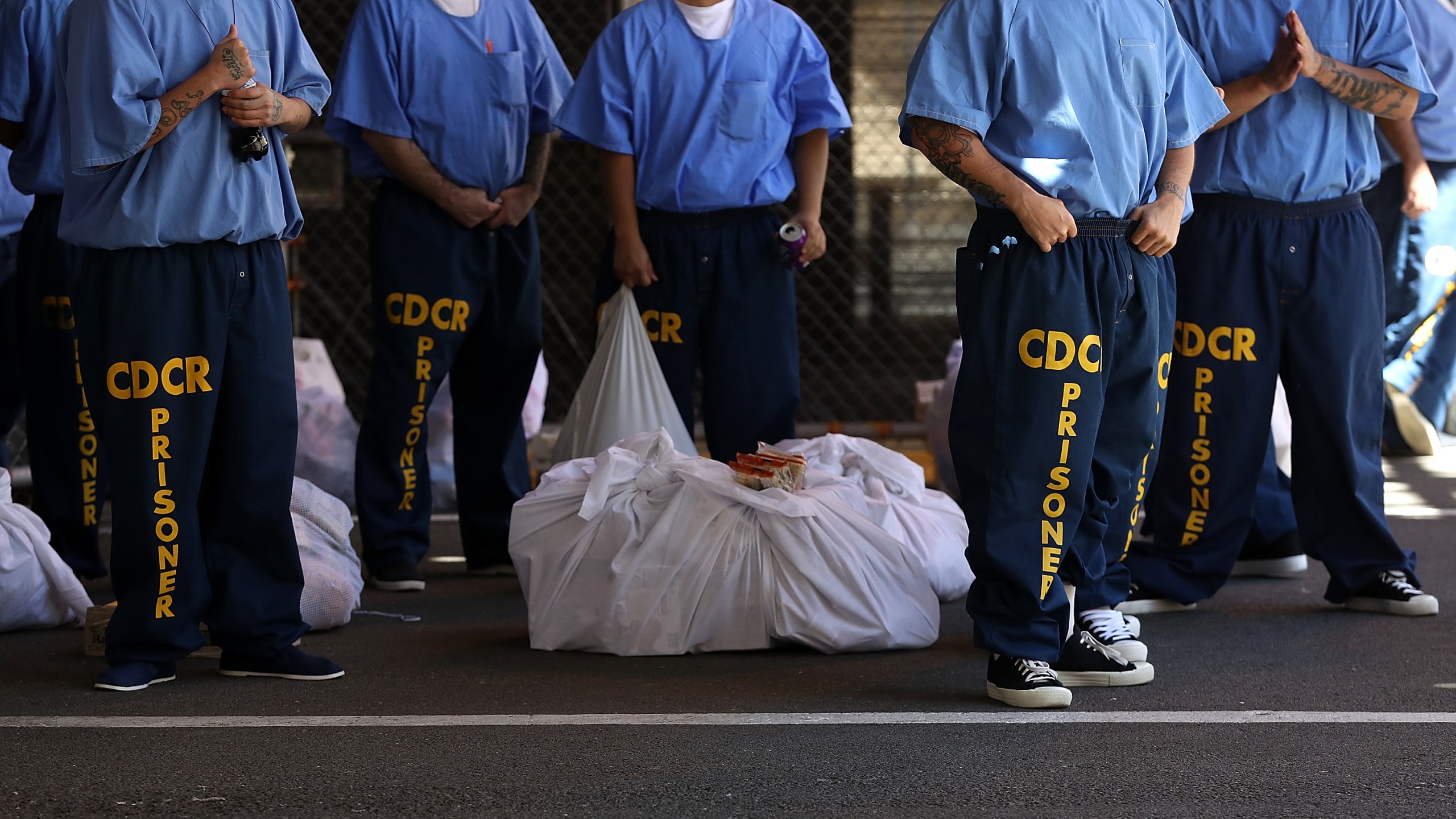 Inmates at San Quentin State Prison wait in line on August 15, 2016 in San Quentin, California. (Photo by Justin Sullivan/Getty Images)