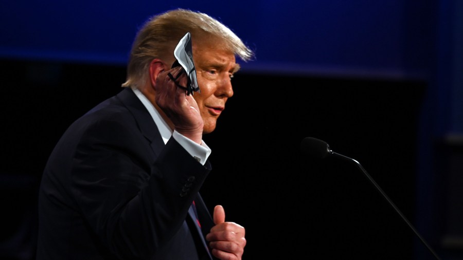 Donald Trump holds a face mask as he speaks during the first presidential debate at the Case Western Reserve University and Cleveland Clinic in Cleveland on Sept. 29, 2020. (JIM WATSON / /AFP via Getty Images)