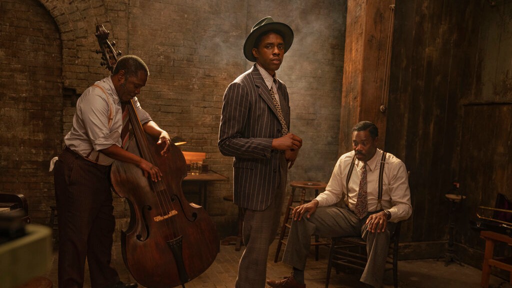 This image released by Netflix shows from left, Michael Potts, Chadwick Boseman and Colman Domingo in "Ma Rainey's Black Bottom." Netflix on Monday previewed George C. Wolfe’s August Wilson adaptation “Ma Rainey’s Black Bottom,” showcasing Chadwick Boseman’s final performance opposite Viola Davis’ powerhouse blues singer. (David Lee/Netflix via AP)