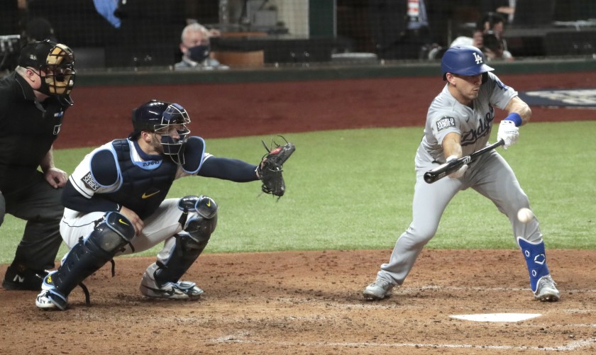 Los Angeles Dodgers' Austin Barnes puts down a fourth-inning squeeze bunt to bring home a run on Oct. 23, 2020 during Game 3 of the World Series in Texas. (Robert Gauthier / Los Angeles Times)