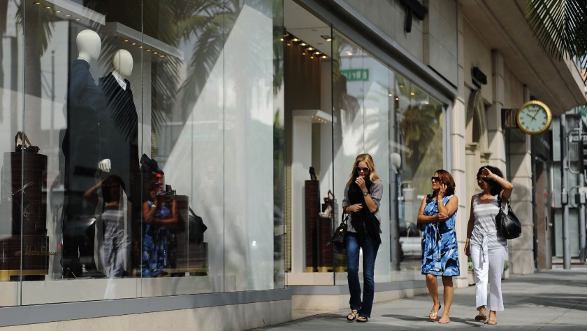 Shoppers along Rodeo Drive in Beverly Hills look into the Salvatore Ferragamo store in 2011.(Mariah Tauger / Los Angeles Times)