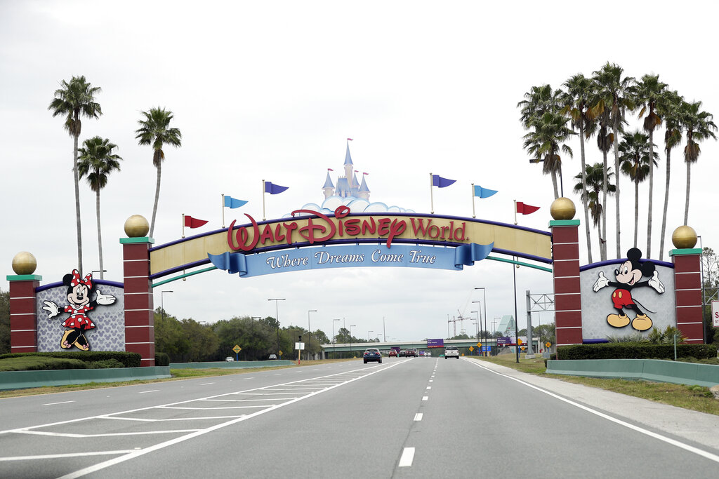 The road to the entrance of Walt Disney World has few cars Monday, March 16, 2020, in Lake Buena Vista. (AP Photo/John Raoux)