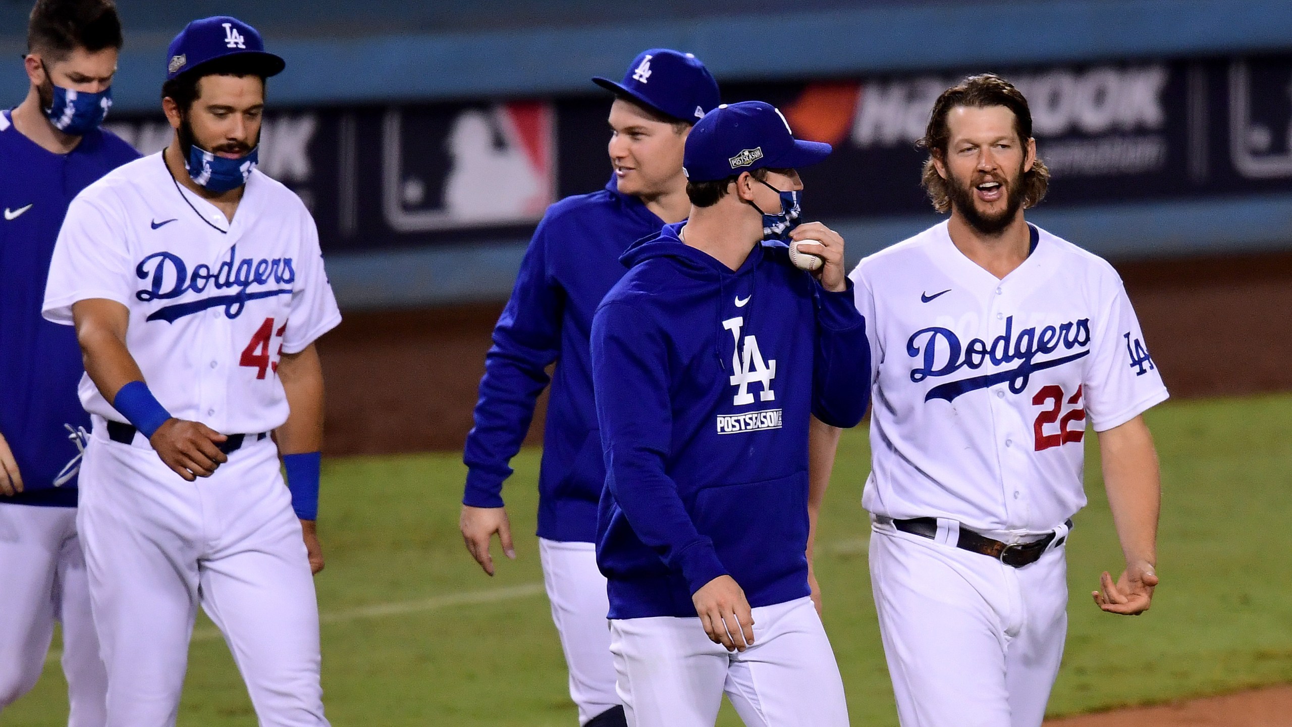 Clayton Kershaw #22 of the Los Angeles Dodgers smiles as he walks on to the field as he celebrate a 3-0 win, to eliminate the Milwaukee Brewers after game two of the National League Wild Card Series at Dodger Stadium on Oct. 1, 2020. (Harry How/Getty Images)