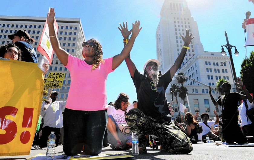 Demonstrators drop to their knees during a march in downtown L.A. in August 2020 as they protested police killings around the country.(Wally Skalij / Los Angeles Times)