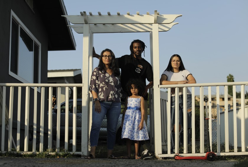 A 2020 photo shows Alma Zaragoza-Petty and Jason Petty, who are teaching daughters Soul, 5, and Luna, 15, to be proud of their parents’ Mexican American and Black heritage. (Myung J. Chun / Los Angeles Times)