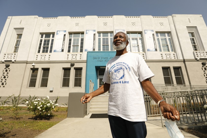 Earl Allen, president of the Jordan High School Alumni Association, in front of his remodeled alma mater, which is shedding its association with a college president who promoted eugenics.(Carolyn Cole / Los Angeles Times)