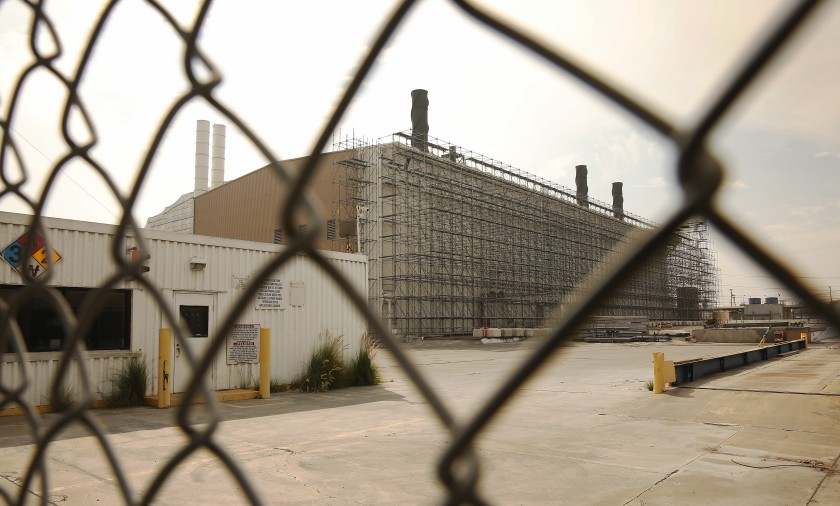 Portions of the former Exide lead-acid battery recycling plant in Vernon are now wrapped in scaffolding and white plastic sheeting.(Al Seib / Los Angeles Times)