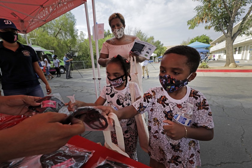 Los Angeles children pick up school supplies in Sylmar in 2020. (Myung J. Chun / Los Angeles Times)