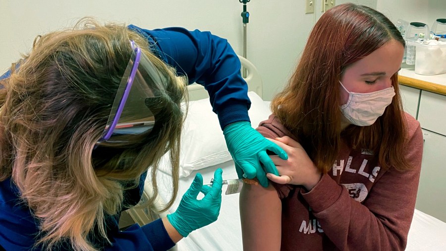 Clinical research coordinator Tammy Lewis-McCauley administers an injection to Katelyn Evans, a trial participant, as part of the hospital’s clinical trial of Pfizer's COVID-19 vaccine on Wednesday, Oct. 14, 2020. (Cincinnati Children’s Hospital Medical Center via AP)