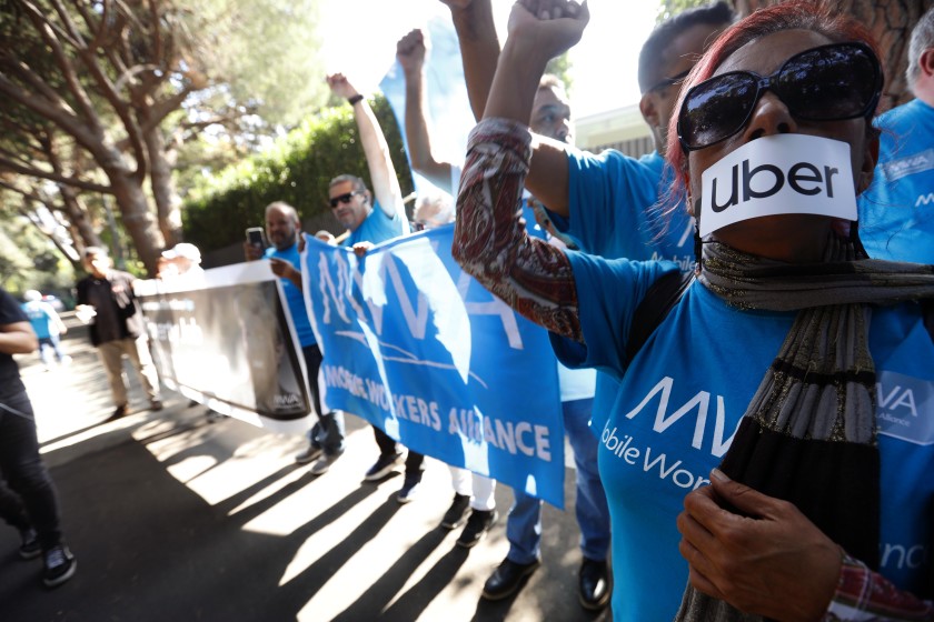 App-based driver Teresa Mercado, right, joins members of the Mobile Workers Alliance, which consists of Uber and Lyft drivers, protesting at the home of Uber co-founder Garrett Camp in Beverly Hills in 2019.(Genaro Molina / Los Angeles Times)