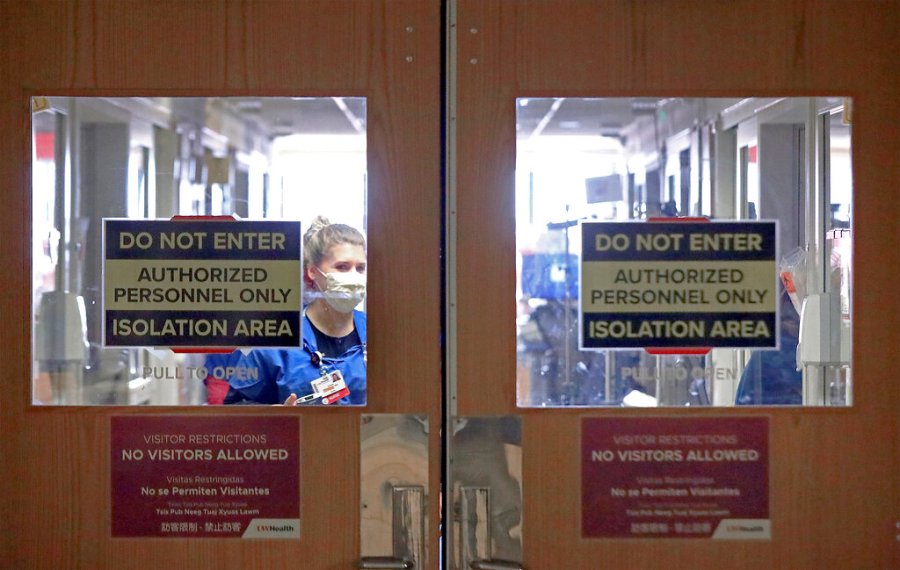 In this Nov. 5, 2020, photo, doors to a COVID-19 treatment unit at UW Health in Madison, Wisconsin, caution hospital personnel and visitors. (John Hart/Wisconsin State Journal via Associated Press)