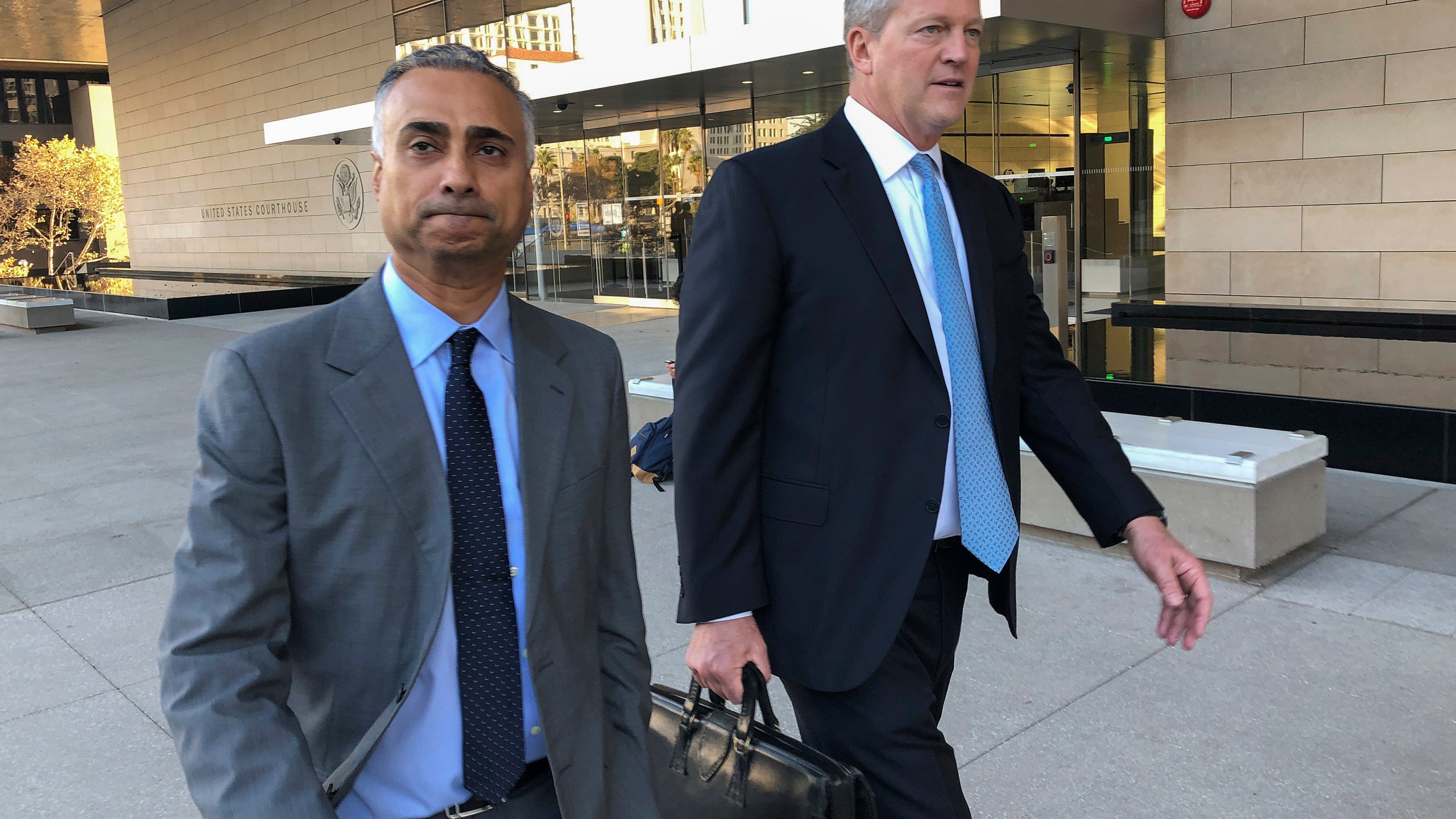 Imaad Zuberi, left, leaves the federal courthouse in Los Angeles with his attorney Thomas O'Brien, right, on Nov. 22, 2019. (Brian Melley / Associated Press)