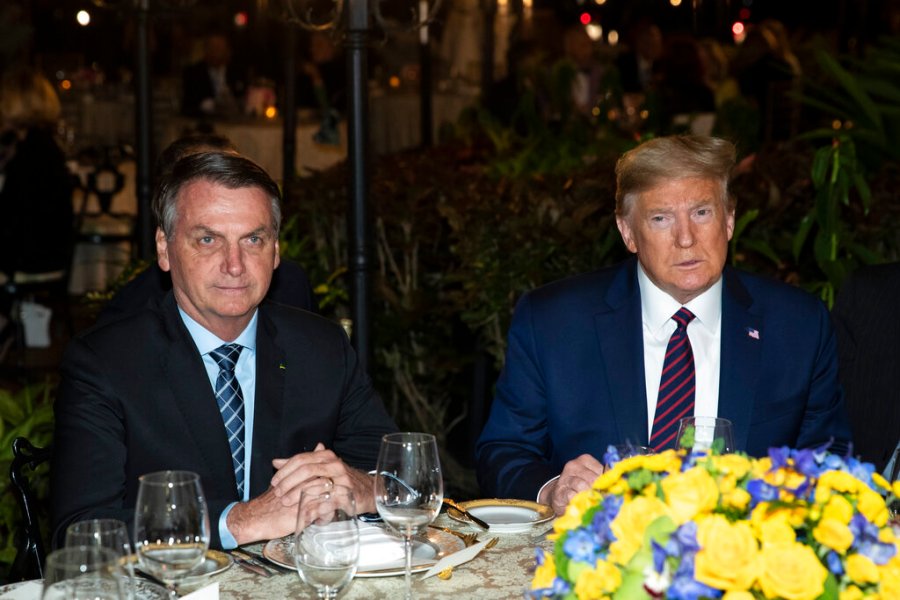 In this March 7, 2020, file photo President Donald Trump is seated before a dinner with Brazilian President Jair Bolsonaro, left, at Mar-a-Lago in Palm Beach, Fla. (AP Photo/Alex Brandon, File)