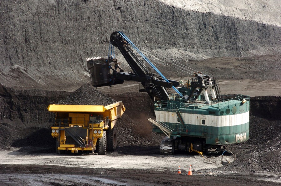 In this April 4, 2013, file photo, a mechanized shovel loads a haul truck with coal at the Spring Creek coal mine near Decker, Mont. (Matthew Brown/AP Photo)