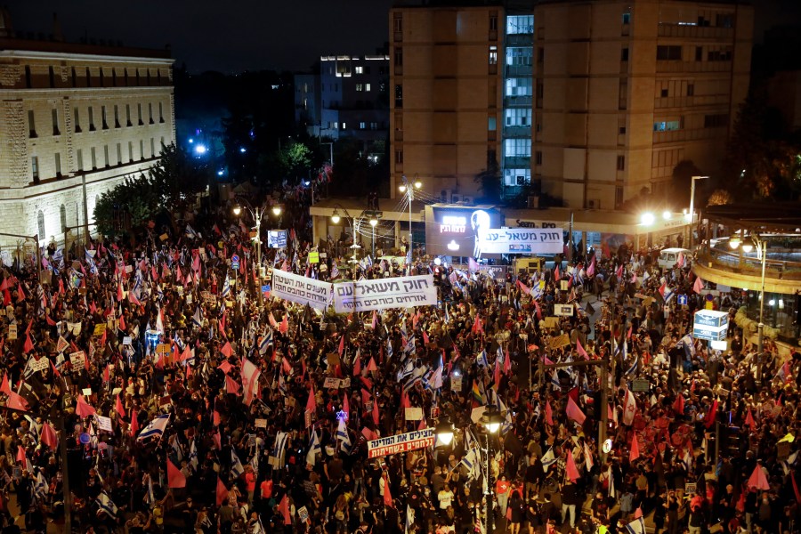 Protesters chant slogans and hold signs during a protest against Israel's Prime Minister Benjamin Netanyahu in Jerusalem, Saturday, Oct. 31, 2020. (Ariel Schalit/AP Photo)