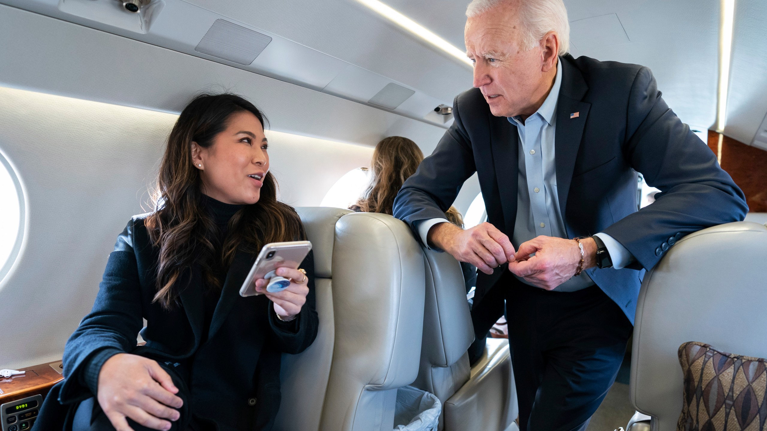 In this photo taken in November 2019, former Vice President Joe Biden speaks with his traveling national press secretary, Remi Yamamoto, on a flight to South Carolina. (Adam Schultz / Biden for President via Associated Press)