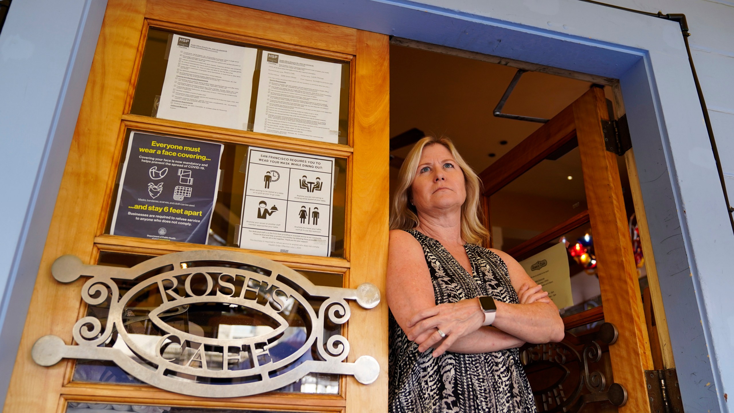 Laurie Thomas poses at the entrance to her Rose's Cafe restaurant in San Francisco on Sept. 28, 2020. (Eric Risberg / Associated Press)