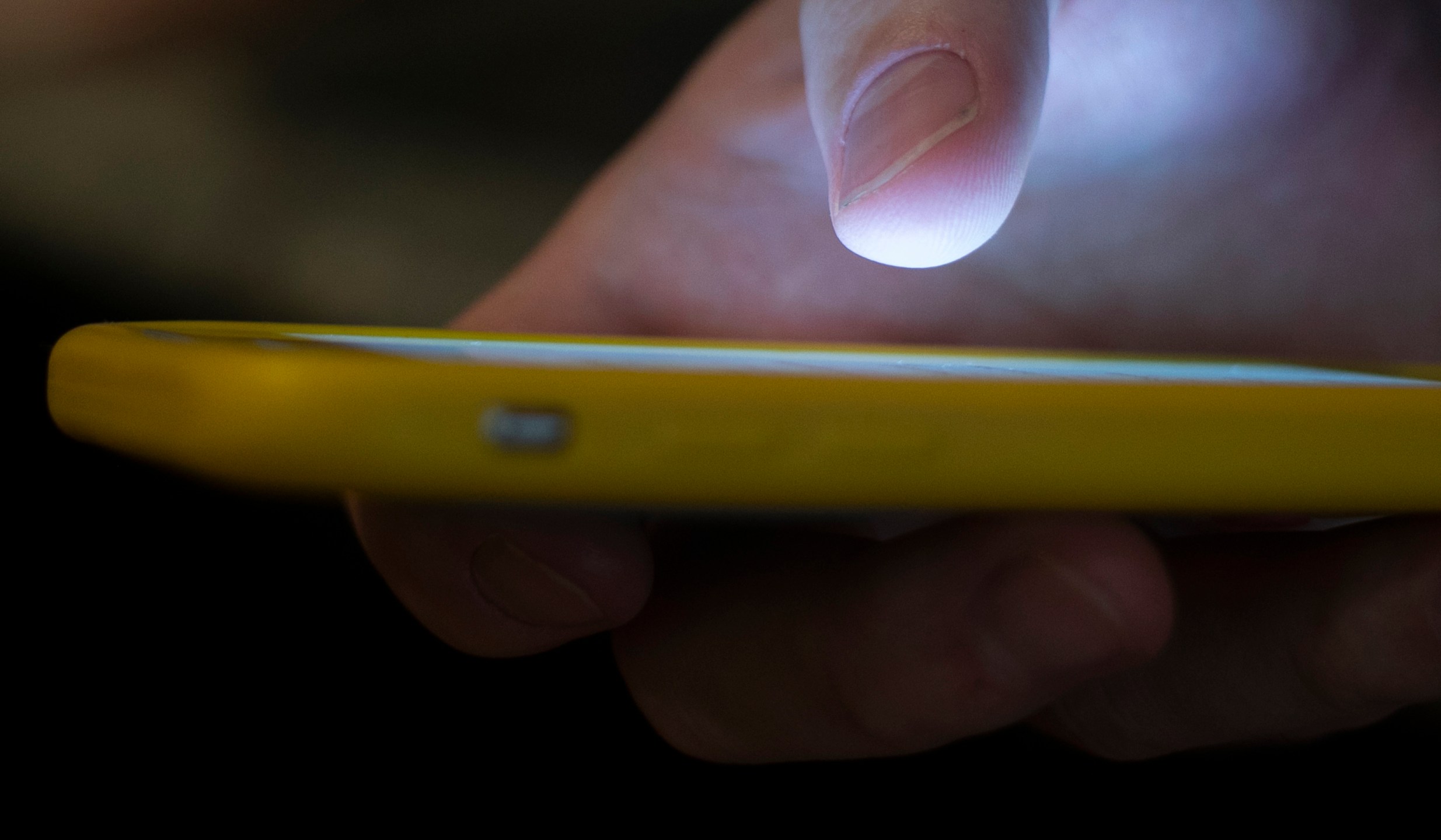 In this Aug. 11, 2019, file photo, a man uses a cellphone in New Orleans. Voters across the U.S. received anonymous robocalls in the days and weeks before Election Day urging them to “stay safe and stay home” — an ominous warning that election experts said could be an effort to scare voters into sitting out the election. (AP Photo/Jenny Kane, File)